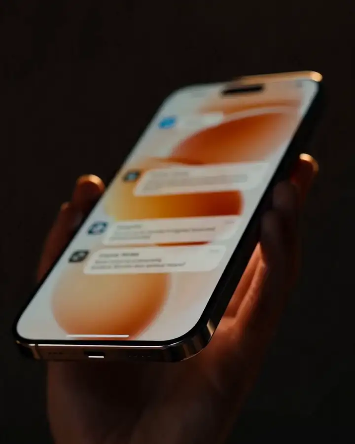 Hand holding a phone showing Lio's reply screen