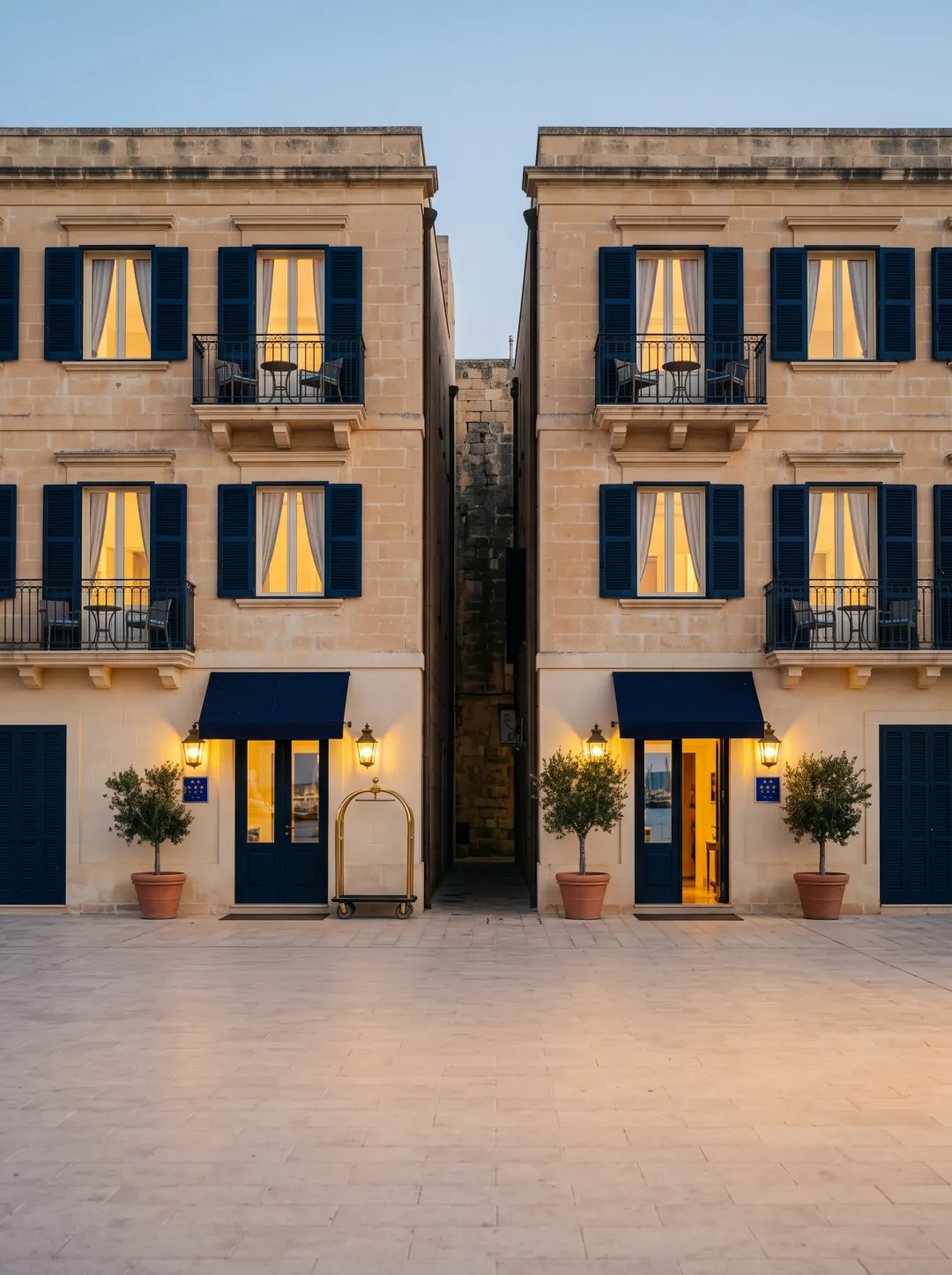 Two matching hotels side by side at dusk